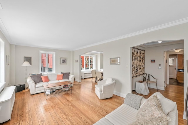 1830 E Kane Pl Unit 3, Milwaukee, WI 53202 - living room featuring arched walkways, radiator heating unit, healthy amount of natural light, ornamental molding, and light wood-style flooring