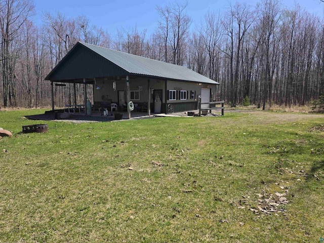 2284 Spirit Ln, La Pointe, WI 54850 - view of property exterior with a lawn, metal roof, and a garage