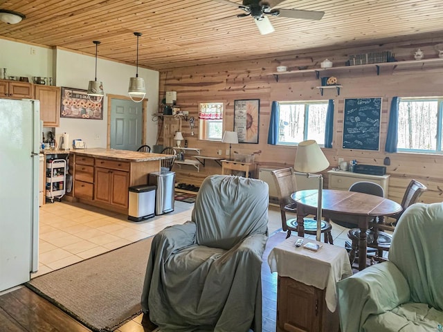 2284 Spirit Ln, La Pointe, WI 54850 - living area featuring wooden ceiling, wood walls, plenty of natural light, ceiling fan, and light tile patterned floors