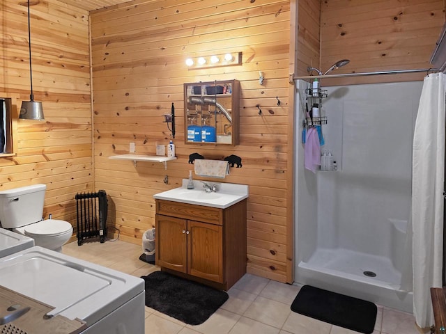 2284 Spirit Ln, La Pointe, WI 54850 - full bathroom featuring a shower stall, tile patterned floors, wood walls, washer / clothes dryer, and toilet
