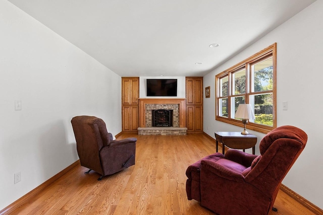 430 Fairview Way, Shawano, WI 54166 - living area with a fireplace with raised hearth, light wood-type flooring, and baseboards