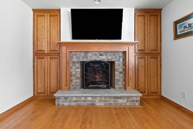 430 Fairview Way, Shawano, WI 54166 - detailed view of wood finished floors, baseboards, and a brick fireplace