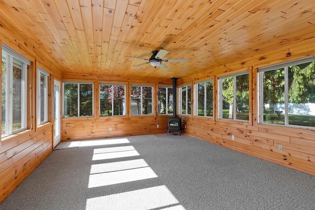 430 Fairview Way, Shawano, WI 54166 - unfurnished sunroom featuring carpet floors, wood walls, a wood stove, and wood ceiling