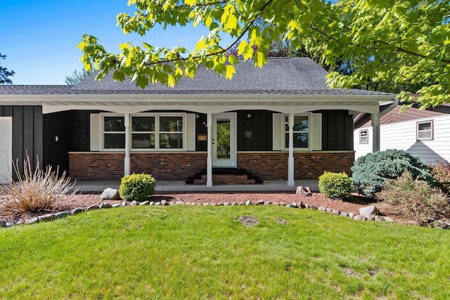 430 Fairview Way, Shawano, WI 54166 - view of front of home with board and batten siding, brick siding, and a front lawn