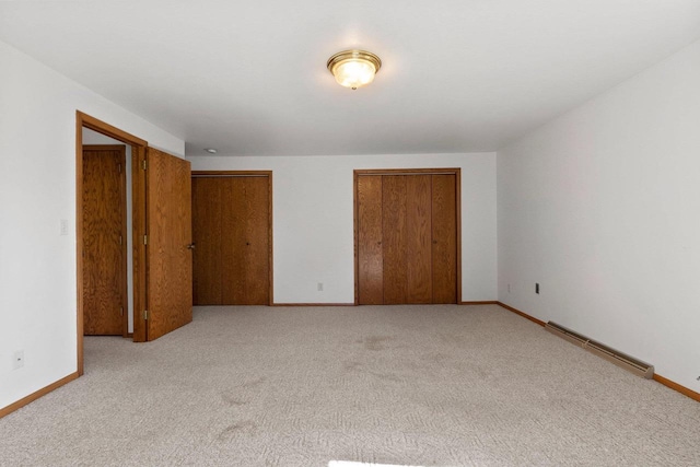 430 Fairview Way, Shawano, WI 54166 - unfurnished bedroom with a baseboard heating unit, light carpet, and baseboards