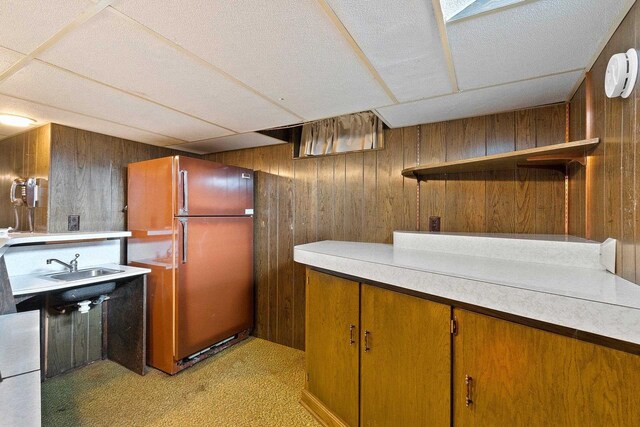 430 Fairview Way, Shawano, WI 54166 - bar with freestanding refrigerator, wooden walls, a sink, and light carpet
