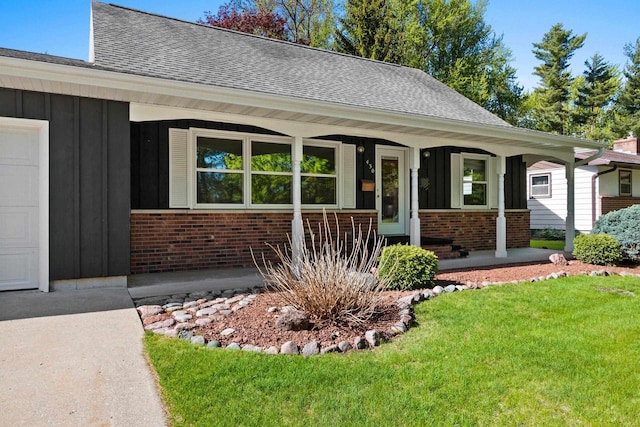 430 Fairview Way, Shawano, WI 54166 - view of front of home with board and batten siding, covered porch, brick siding, and a shingled roof