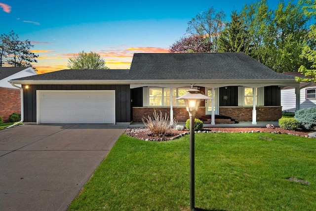 430 Fairview Way, Shawano, WI 54166 - view of front facade with an attached garage, driveway, board and batten siding, a lawn, and a shingled roof