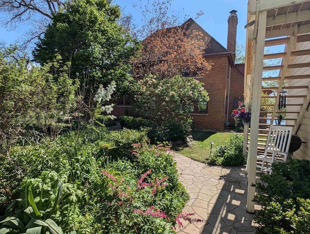109 Doty St, Fremont, WI 54940 - view of property exterior featuring brick siding, stairway, and a chimney