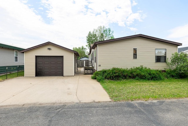 26 Westminster Ave, Holmen, WI 54636 - view of side of property with a garage, an outdoor structure, and driveway