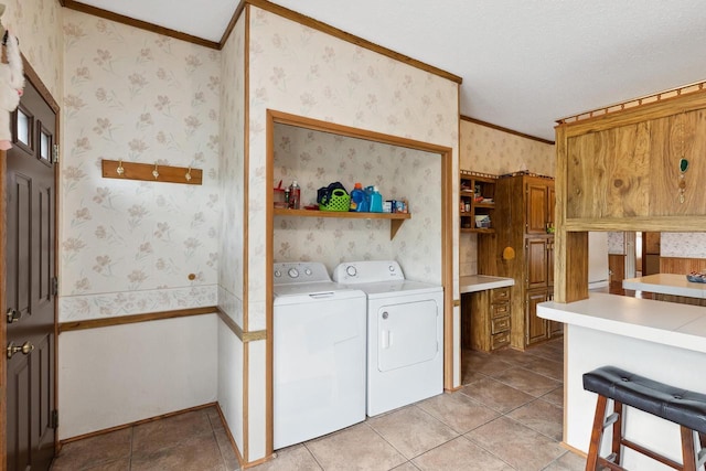 26 Westminster Ave, Holmen, WI 54636 - laundry area with washer and clothes dryer, ornamental molding, wallpapered walls, light tile patterned floors, and a textured ceiling