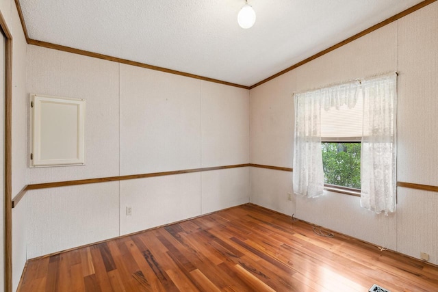 26 Westminster Ave, Holmen, WI 54636 - spare room with lofted ceiling, crown molding, and wood finished floors