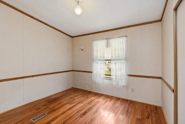 26 Westminster Ave, Holmen, WI 54636 - spare room featuring ornamental molding and wood finished floors