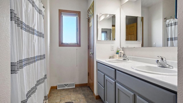 13213 138th Ave, Chippewa Falls, WI 54729 - full bathroom with baseboards, double vanity, and stone finish flooring