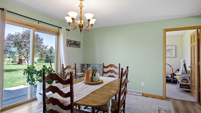13213 138th Ave, Chippewa Falls, WI 54729 - dining space featuring a chandelier, wood finished floors, and baseboards