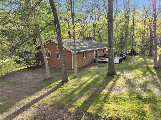 600 Honey Bear Ct, Waupaca, WI 54981 - view of side of home with a wooden deck, a lawn, and central AC