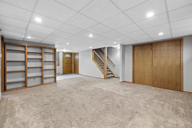 167 W Paradise Dr, West Bend, WI 53095 - finished below grade area with stairs, carpet flooring, recessed lighting, a baseboard heating unit, and baseboards
