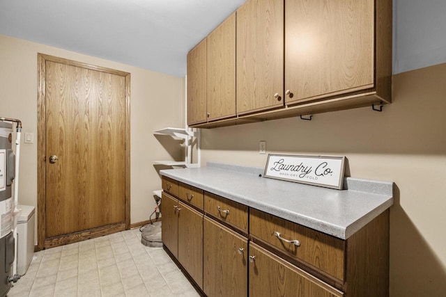 167 W Paradise Dr, West Bend, WI 53095 - laundry room featuring cabinet space