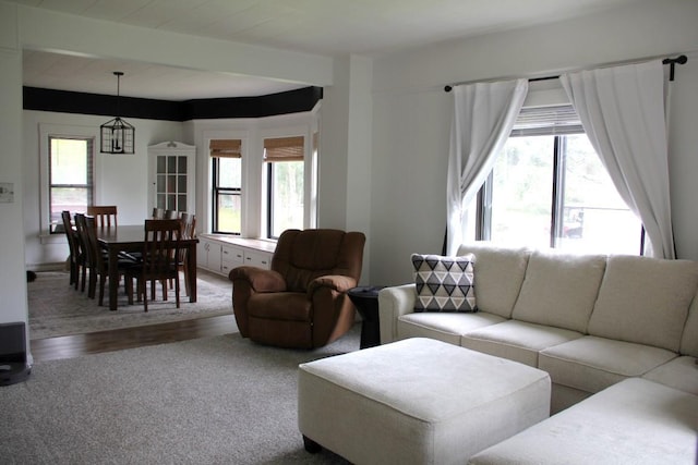 214 E Charles St, Schofield, WI 54476 - living area featuring plenty of natural light, carpet floors, wood finished floors, and beam ceiling