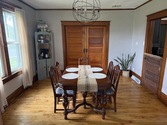 N2089 Double D Rd, Campbellsport, WI 53010 - dining space featuring light wood-style flooring, crown molding, a chandelier, and plenty of natural light
