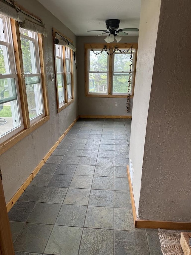 N2089 Double D Rd, Campbellsport, WI 53010 - unfurnished sunroom featuring a textured wall and baseboards