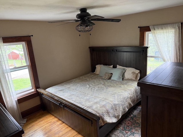 N2089 Double D Rd, Campbellsport, WI 53010 - bedroom featuring multiple windows, light wood-style flooring, and a ceiling fan