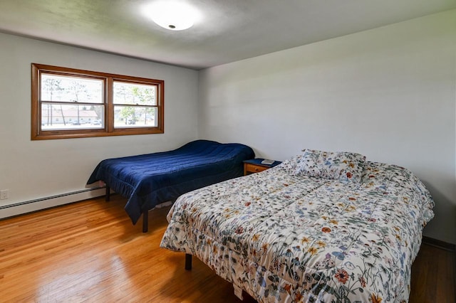 7628 W Mineral Point Rd, Verona, WI 53593 - bedroom featuring wood finished floors and a baseboard radiator