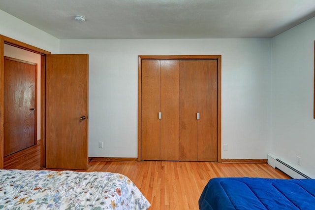 7628 W Mineral Point Rd, Verona, WI 53593 - bedroom featuring a baseboard heating unit, wood finished floors, and baseboards