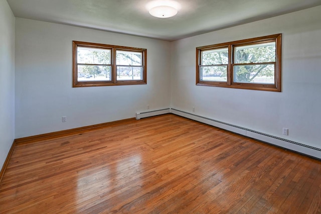 7628 W Mineral Point Rd, Verona, WI 53593 - unfurnished room with plenty of natural light, wood finished floors, and baseboard heating