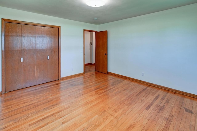 7628 W Mineral Point Rd, Verona, WI 53593 - unfurnished bedroom with baseboards, light wood-style floors, and a closet