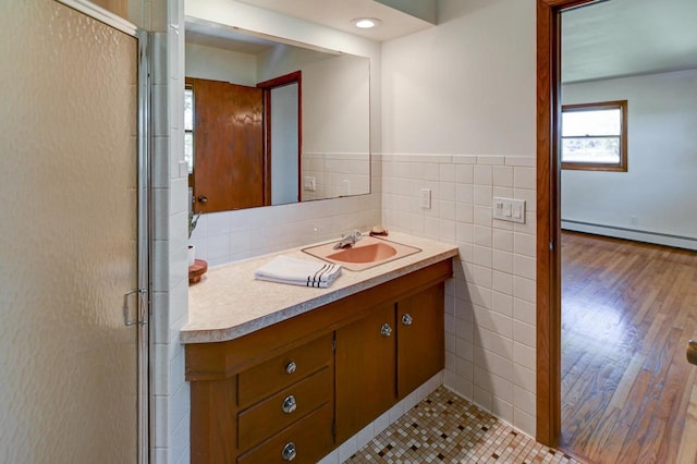 7628 W Mineral Point Rd, Verona, WI 53593 - full bath with tile walls, baseboard heating, vanity, a stall shower, and wood finished floors