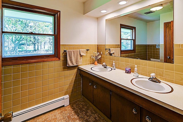7628 W Mineral Point Rd, Verona, WI 53593 - full bath featuring a baseboard radiator, double vanity, tile walls, a wainscoted wall, and recessed lighting