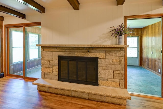 7628 W Mineral Point Rd, Verona, WI 53593 - detailed view of beamed ceiling, a stone fireplace, wood finished floors, and wooden walls