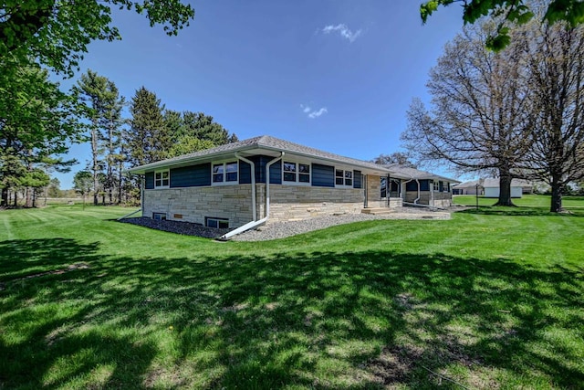 7628 W Mineral Point Rd, Verona, WI 53593 - back of property with stone siding, a yard, and a sunroom