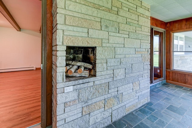 7628 W Mineral Point Rd, Verona, WI 53593 - detailed view of wooden walls, a baseboard heating unit, and a stone fireplace