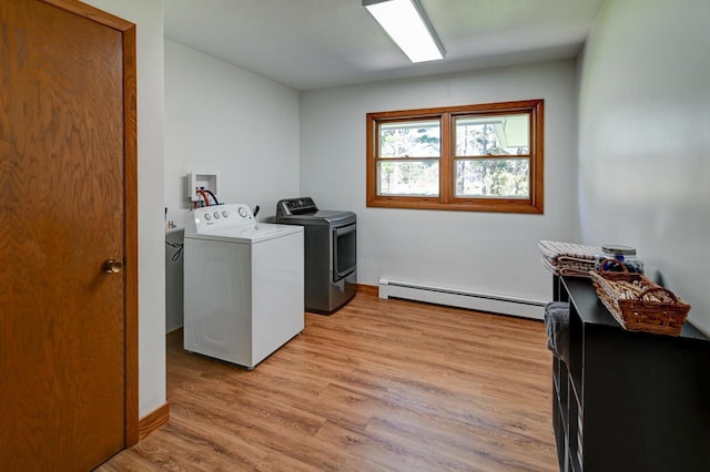 7628 W Mineral Point Rd, Verona, WI 53593 - laundry area featuring a baseboard heating unit, washing machine and dryer, light wood finished floors, and baseboards