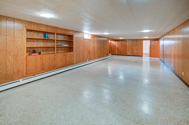 7628 W Mineral Point Rd, Verona, WI 53593 - finished below grade area with wood walls, a baseboard heating unit, light floors, built in features, and baseboards