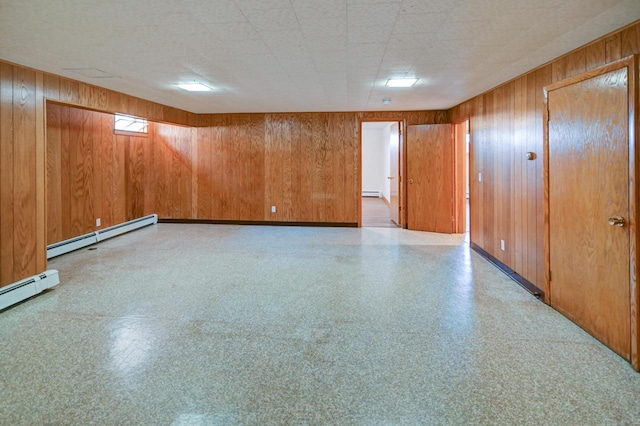 7628 W Mineral Point Rd, Verona, WI 53593 - unfurnished room with a baseboard heating unit, wooden walls, baseboard heating, and baseboards
