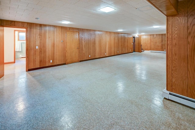 7628 W Mineral Point Rd, Verona, WI 53593 - basement featuring wood walls, light flooring, baseboard heating, a baseboard radiator, and baseboards