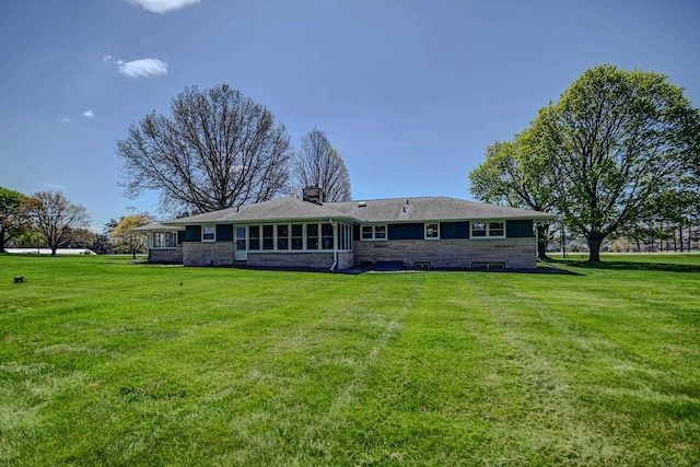 7628 W Mineral Point Rd, Verona, WI 53593 - back of property featuring stone siding, a lawn, and a chimney