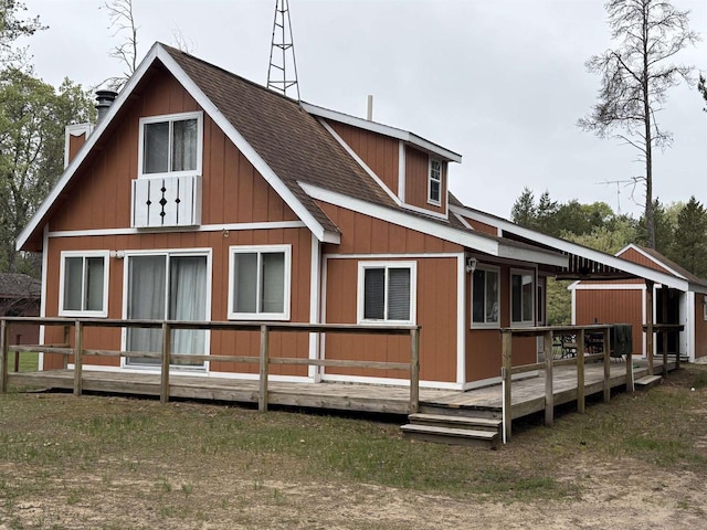W5946 Beach Dr, New Lisbon, WI 53950 - back of house featuring a wooden deck, roof with shingles, and a chimney