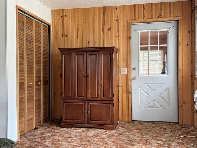 W5946 Beach Dr, New Lisbon, WI 53950 - doorway featuring carpet flooring and wood walls