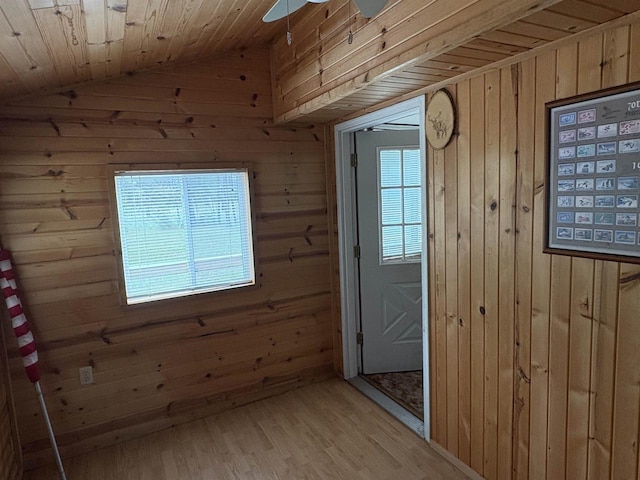 W5946 Beach Dr, New Lisbon, WI 53950 - doorway to outside with wooden walls, light wood-style floors, ceiling fan, and vaulted ceiling
