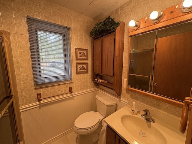 W5946 Beach Dr, New Lisbon, WI 53950 - bathroom with toilet, vanity, an enclosed shower, and a wainscoted wall
