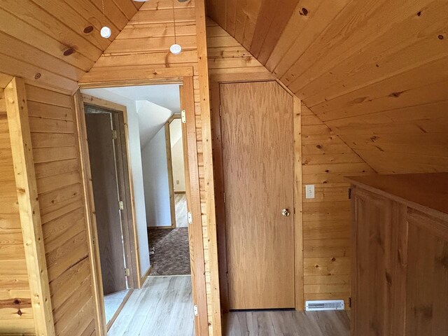 W5946 Beach Dr, New Lisbon, WI 53950 - additional living space with lofted ceiling, wooden walls, wooden ceiling, and light wood finished floors