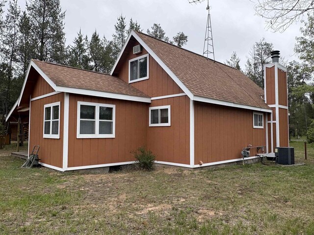 W5946 Beach Dr, New Lisbon, WI 53950 - view of property exterior with roof with shingles, a yard, central AC, and a chimney