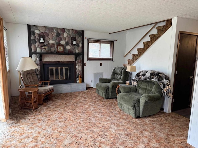 W5946 Beach Dr, New Lisbon, WI 53950 - carpeted living area featuring a stone fireplace and stairs