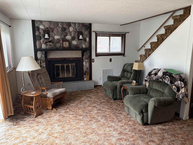W5946 Beach Dr, New Lisbon, WI 53950 - carpeted living room featuring a stone fireplace and stairway
