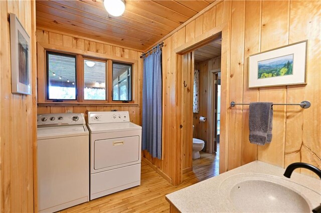 12642 Paddock Rd, Hayward, WI 54843 - laundry room with washing machine and clothes dryer, wooden walls, light wood-style floors, and wood ceiling