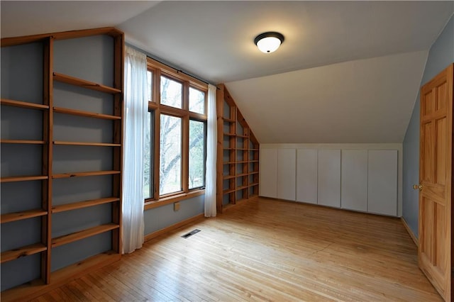 12642 Paddock Rd, Hayward, WI 54843 - additional living space with lofted ceiling and light wood-style floors